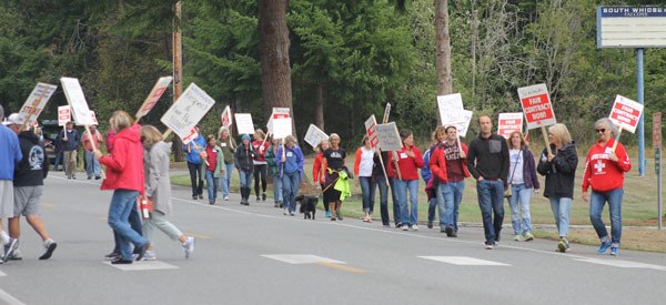 South Whidbey school teachers picket on Maxwelton Road Thursday morning. They agreed to strike at a meeting last night following the latest collective bargaining agreement offered by the school district.