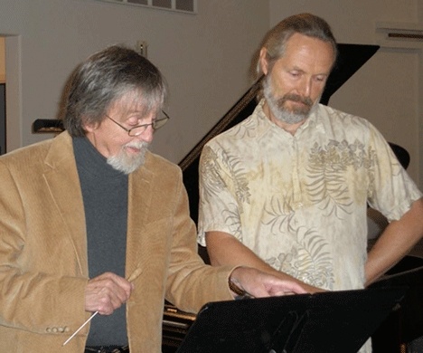 Conductor Legh Burns peruses sheet music with Karl Olsen during a recent rehearsal for the Saratoga Chamber Orchestra’s upcoming season opener “The Mighty Fifth