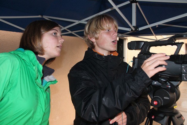 Elli Sandberg and Joe Davies operate the camera at South Whidbey High School’s first home football game of the season.