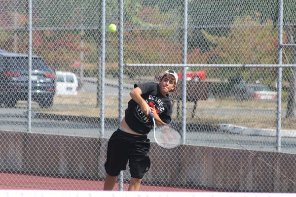 Falcons senior varsity player Loel Nichols serves a ball during practice.