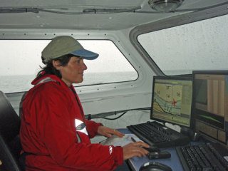 Coupeville Middle School science teacher Terry Welch learns to use the navigational tools onboard the NOAA ship Rainier. Welch took part in the “Teacher at Sea” program