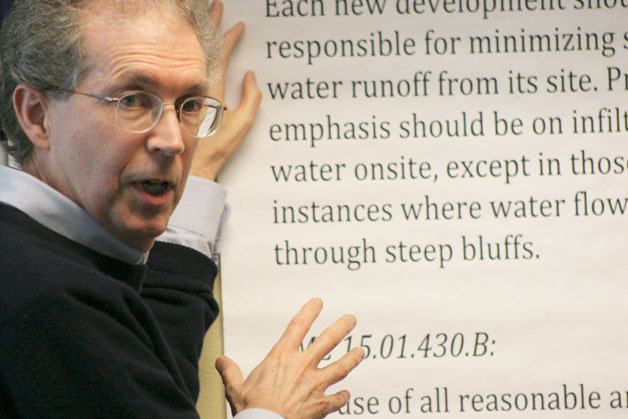 Langley City Councilman Robert Gilman refers to a poster he brought to the city council meeting Tuesday as he explains his take on city requirements for new development.