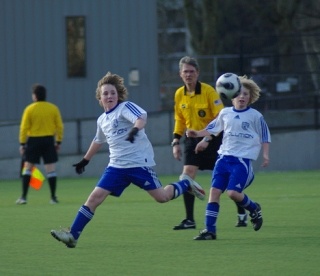 Revolution U-12 soccer players Donald Gambill and Kameron Donohoe fire the ball to a teammate Saturday during their 2-0 victory in the Commissioner’s Cup semi-final game in Tukwila.
