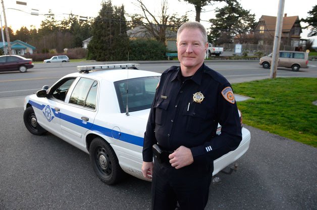 Coupeville Deputy Marshal Hodges Gowdey poses for a photo on Main Street. A proposal concerning the management of the Coupeville Marshal's Office is now being considered by the town council.