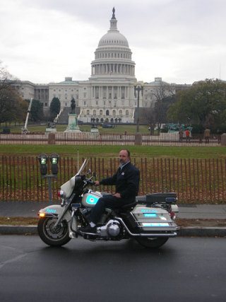 Gordy Grove of Langley poses on a police motorcycle in front of the Capitol building on his first tree-trucking trip to Washington