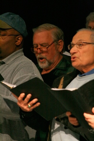 Wica Conservatory Choir members Frank O’Brochta and Norman Walker sing out at rehearsal for “In A Yellow Wood.” At top