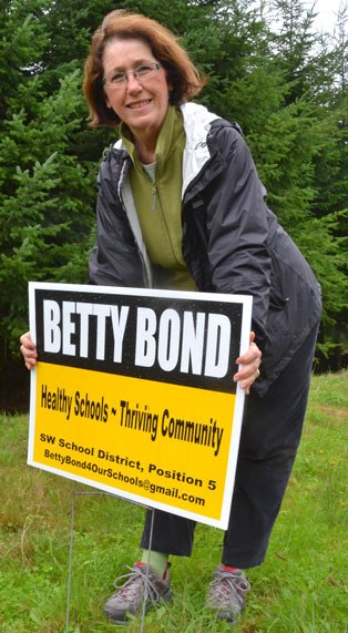 Betty Bond stakes one of her campaign signs after vandals removed and damaged several over the past couple of weeks. She is running for the South Whidbey School Board against Rocco Gianni