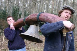 Michael Scullin and sculptor Tim Leonard hoist the bell that will become Langley’s early-warning system for visiting whales. Scullin