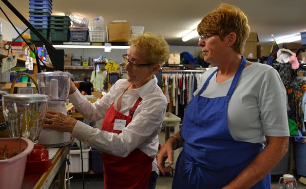 Volunteers Ellie Maloney and Mary Pat Stone sort housewares at Senior Services Community Thrift Store.