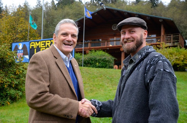 Whidbey Veterans Resource Center President Greg Stone shakes hands with Lucas Jushinski at the organization’s South Whidbey headquarters. Jushinski is helping the nonprofit boost a fundraiser with a $10