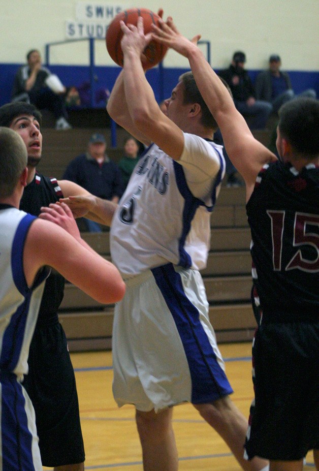Nick Bennett’s drive to the rim against Cedarcrest gets blocked from behind.