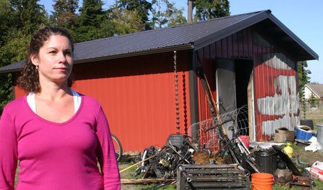 Robin Koeller stands outside the family’s gutted metal garage