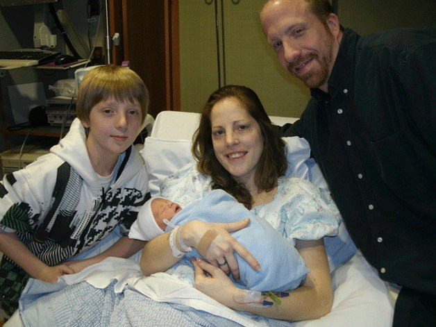 Baby Curtis Raymond Hastings is held by his mother