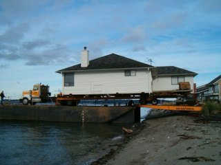 This 3-bedroom house near Mutiny Bay in Freeland is loaded onto a barge to be transported to Everett. An Everett company recycles unwanted houses