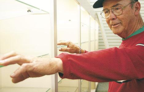 Don Dillon of Langley prepares Monday to remove a section of shelving in the pharmacy department of the former Linds Langley Drug. The shelving will go to Good Cheer’s Langley Thrift Store.