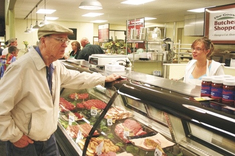 The Goose gourmet meat department employee Tiea Matzen of Clinton waits on Dave Jones of Possession Shores. Jones was shopping for filet mignon.