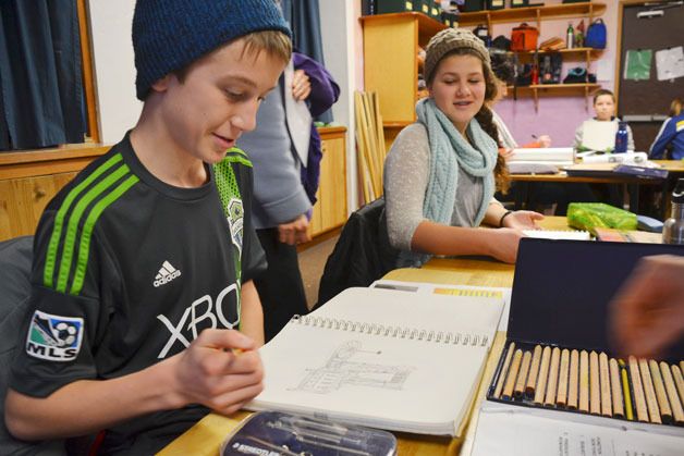 John Thomas works on his class notebook in Angela Lindstrom’s 8th grade class at Whidbey Island Waldorf School. The class will venture to the Moab desert later this month for a culminating class field trip.