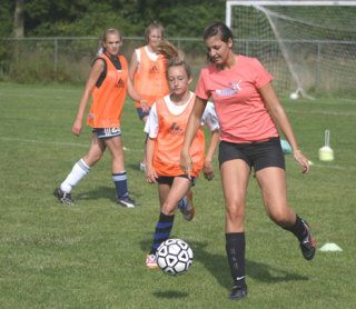 Cortney Fredriksen and Katharina Hoefler battle for the soccer ball during a Falcons' practice session.