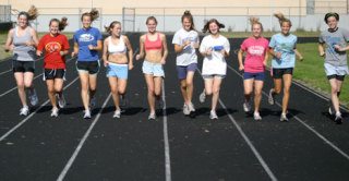 The girls cross country team celebrates finishing their daily run last week. This year’s team includes Jessica Cary
