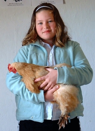 Meaghan De Wolfe demonstrates the proper way to hold a chicken.