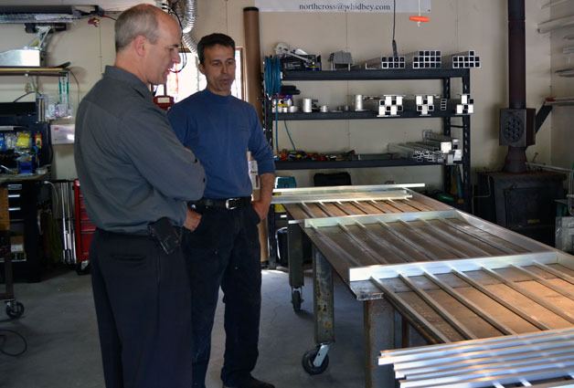 Rep. Rick Larsen examines the aluminum work at Tim Leonard's North Cross Aluminum in Freeland. The shop won the bid to build a nearly $500