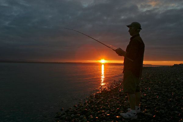 Kevin Lungren gets in a few more casts just before sundown Sunday at South Whidbey State Park. The longtime angler parted with a few trade secrets on a fighting venture with a South Whidbey Record reporter. Lungren