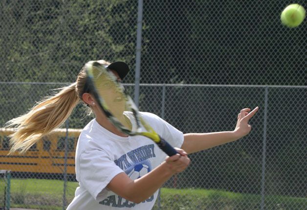 Falcon senior Hayley Newman approaches the net for a volley in this match against Coupeville in May. She finished second in the state 1A girls tennis singles tournament.