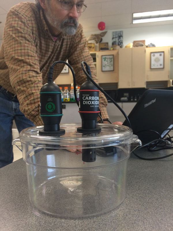 South Whidbey High School biology teacher Greg Ballog demonstrates using computer probes to measure atmospheric carbon.