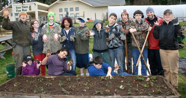 HUB youths take a break during a day of gardening at the Good Cheer Food Bank. From the left are Good Cheer Garden Coordinator Cary Peterson