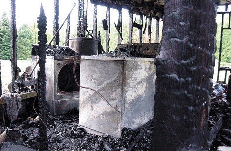 The charred dryer at left is blamed for starting a fire in Freeland on Saturday morning that destroyed this mobile home and killed a number of pets. The home’s occupant escaped uninjured.