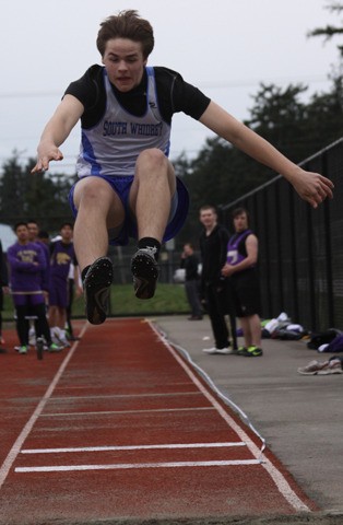 Nate Hanson leaps for the long jump pit March 14 at Oak Harbor.