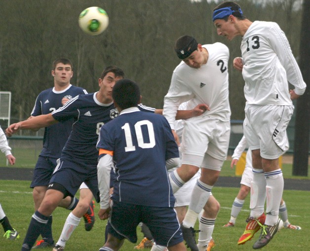 South Whidbey’s Calvin Shimada and Bryce Auburn track a header that misses wide against Sultan on April 2.