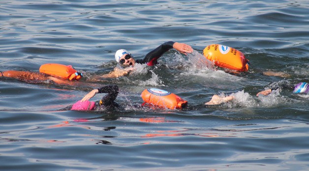 Jeff Jacobsen takes a breath while swimming with his fellow South Whidbey Island Masters swimmers in Saratoga Passage off Seawall Park in Langley on July 1.