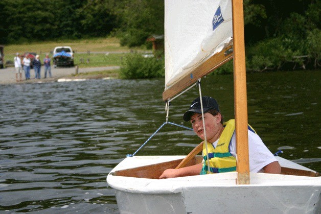 Conor Workman steers his El Toro into the wind and away from the safety boat during sailing class.