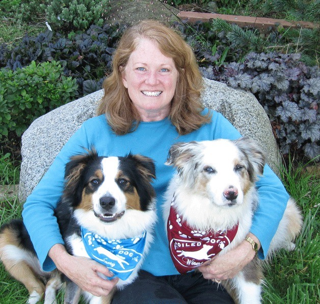 Spoiled Dog Winery co-owner Karen Krug happily holds her noted spoiled doggies.