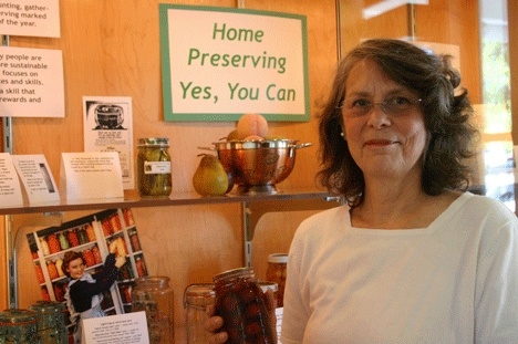 Sue Ellen White stands at her Freeland Library display on the benefits of canning your own food.