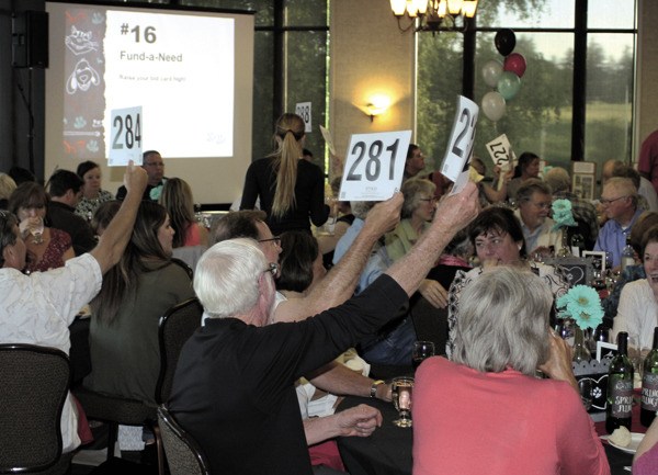 People participate in the Whidbey Animal Improvement Foundation's 12th annual Spring Fling Gala Auction and Gourmet Dinner. The event raised more than $120