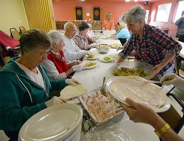 Readiness to Learn volunteers help prepare box lunches for a fundraiser last Wednesday morning. The organization sold 371 lunches in all