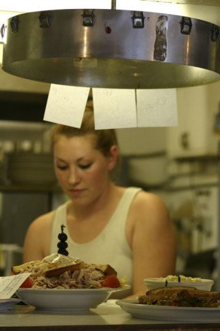 Sara Goss prepares orders on Wednesday at Neil’s Clover Patch