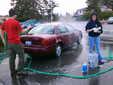 Guy O’Connor and Avery Grant contribute to the clean-car brigade at Chase Bank in February.