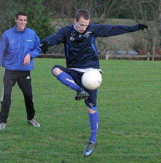 French soccer star Sylvain Mace juggles the ball as Sebastien Le Toux waits his turn Thursday during a practice drill at the French Soccer Academy in Langley.