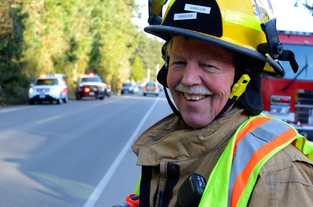 Gary Gabelein smiles while directing traffic at a recent car accident in Freeland. The longtime firefighter retired this month after 43 years as a South Whidbey Fire/EMS volunteer.