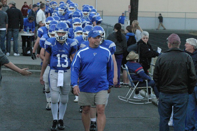 Falcon coach Mark Hodson walks out with the team during last season’s home game against Cedarcrest. The 10-year SWHS coach has stepped down from his leadership role with the football team.