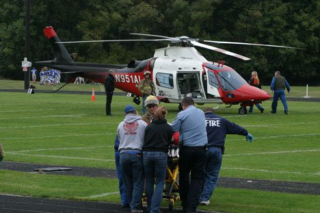 A fall victim is taken to an Airlift Northwest medivac helicopter at South Whidbey High School late Monday.