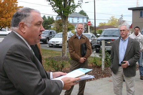 Everett attorney Thomas Adams conducts a default sale of the former 750-acre Trillium Woods property on Friday in Coupeville. Listening are Jeff Lewis (left)