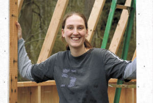 Malina Vande Werfhorst stands in a shed near her Habitat home-to-be in Greenbank.
