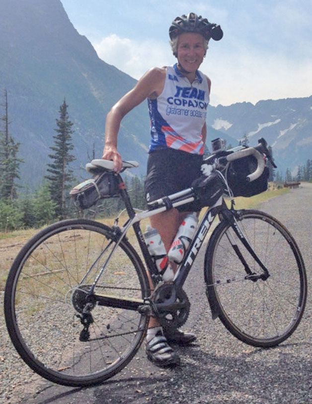 Diane Mattens takes a break as she bikes along the North Cascade Scenic Highway in early August. She pedaled from Maine to Seattle