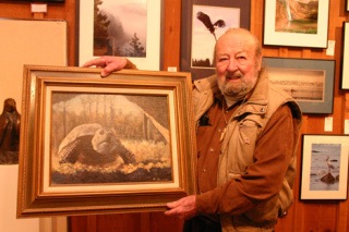 Artist Ted Basrak shows off one of his oil paintings at the Whidbey Artists Gallery in Langley. Basrak died Nov. 16 at home in Clinton.