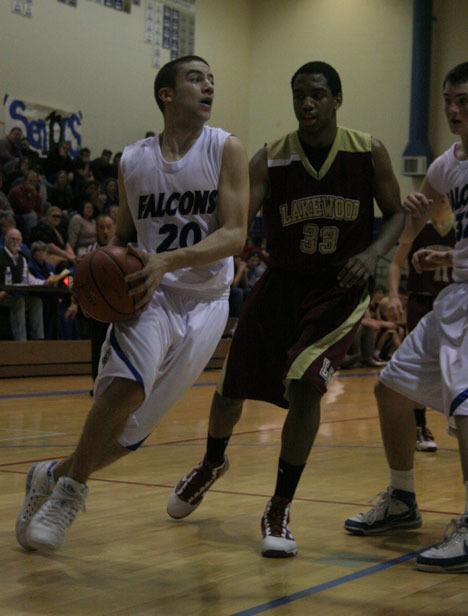 South Whidbey’s Jordan Thornely drives to the rim against the Cougars’ Tre Haslom during last week’s match-up in Langley.