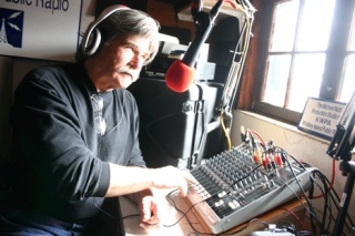 William Bell works the controls in the Michael Nutt Production Studio at KWPA radio station on Coupeville Wharf.